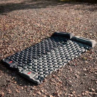 TrekPad ULTRALIGHT self-inflating camping mattress with built-in pillow on gravel ground — ultralight sleeping pad for camping outdoors