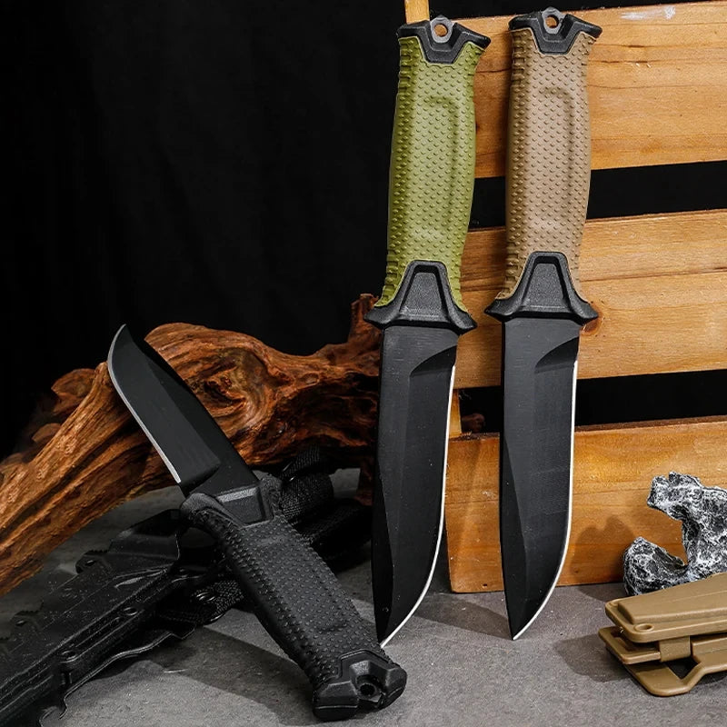 Three knives with black blades and various handles on a wooden background