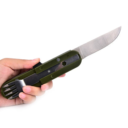 Hand holding a multi-tool with knife blade, fork, and spoon on a white background