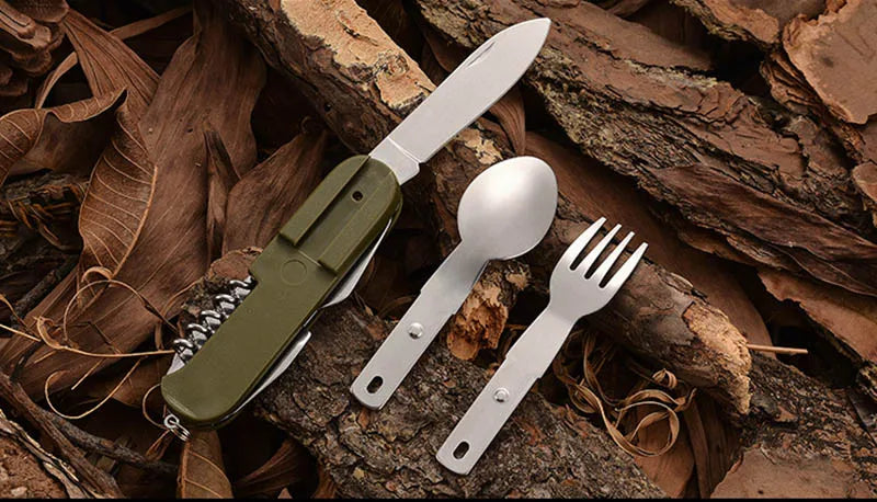 Set of camping cutlery including a knife, spoon, and fork on a natural background.