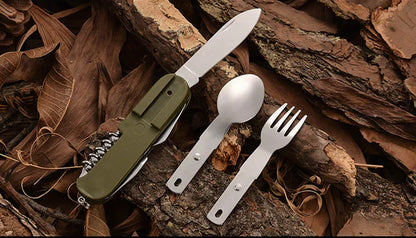 Set of camping cutlery including a knife, spoon, and fork on a natural background.