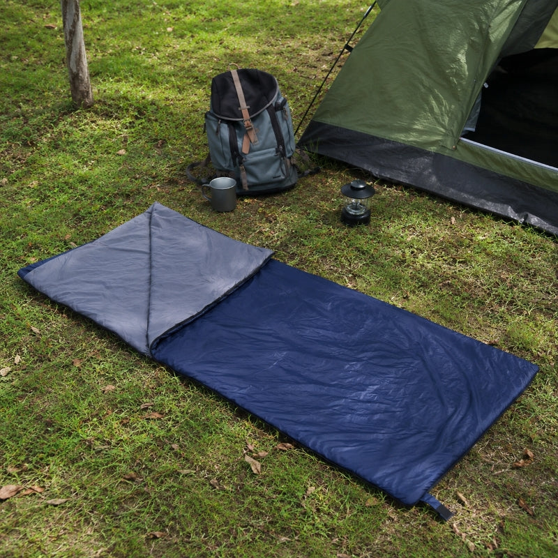 Hand holding compressed ultralight sleeping bag stuff sack showing compact size