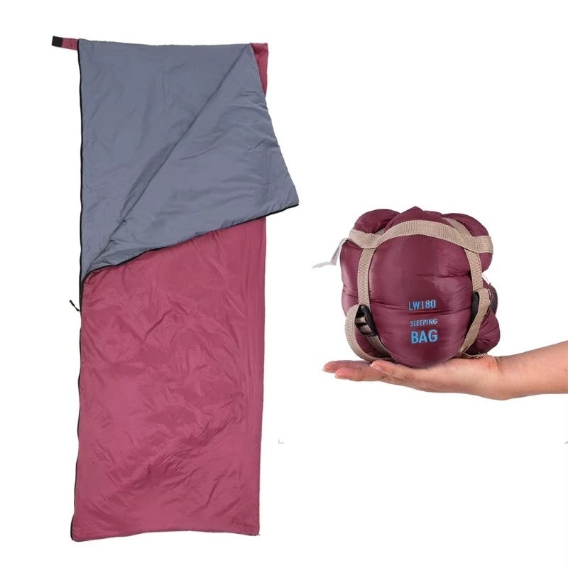 Ultralight sleeping bag in burgundy shown open and compressed side by side