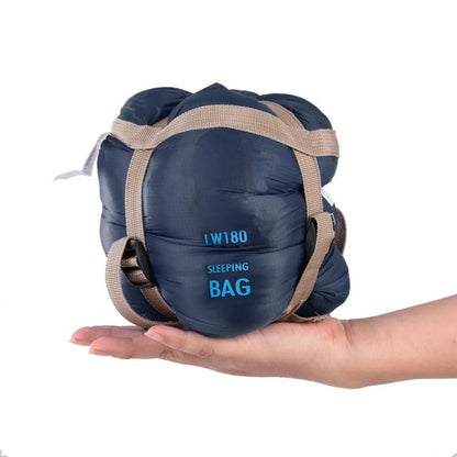 680g ultralight sleeping bag in navy blue compressed, held in one hand