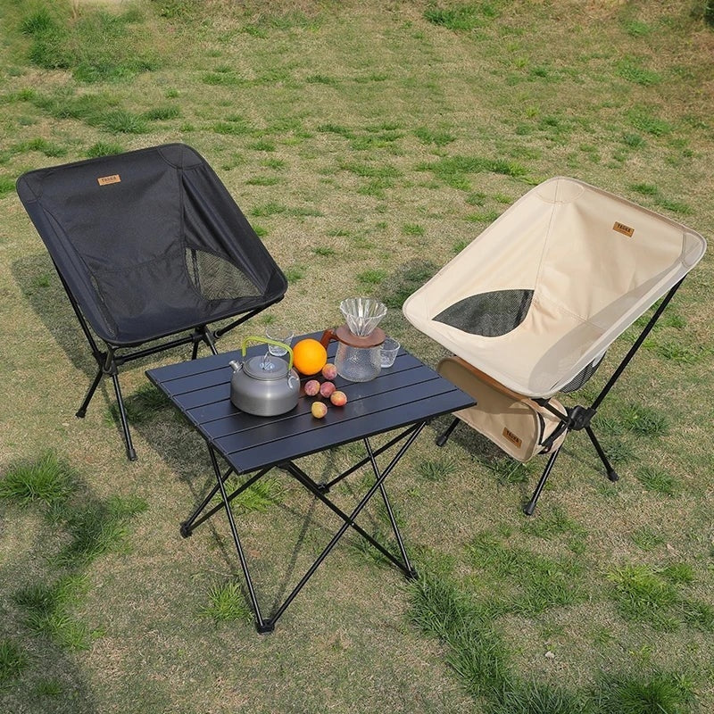 Two folding camping chairs and table set up outdoors — lightweight portable camping chair set