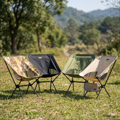 Multiple folding camping chairs set up on grass at a campsite — lightweight portable outdoor chairs