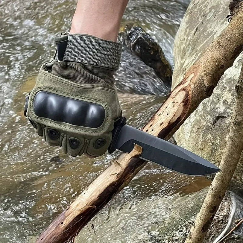 Fixed blade survival knife cutting wood near river, durable camping knife for bushcraft and outdoor use