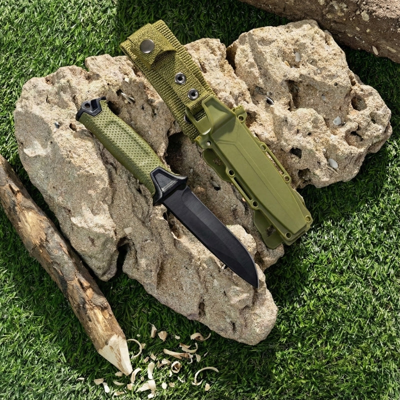 Fixed blade survival knife with sheath, outdoor camping and bushcraft knife displayed on rocks