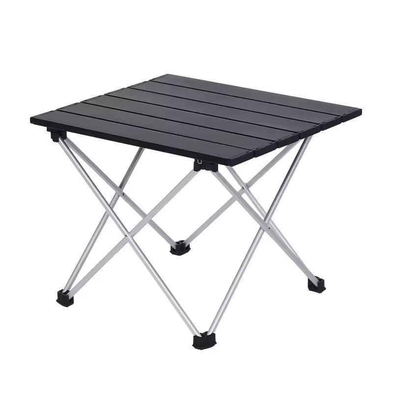 Portable folding camping table with aluminium slatted top and X-frame legs, studio shot